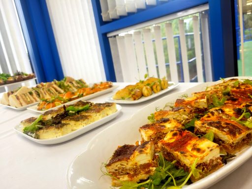 A photo of a buffet table with several plates of food